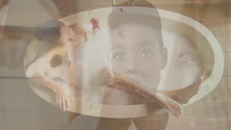 animation of thoughtful child's face overlaying woman relaxing in bathtub with wine
