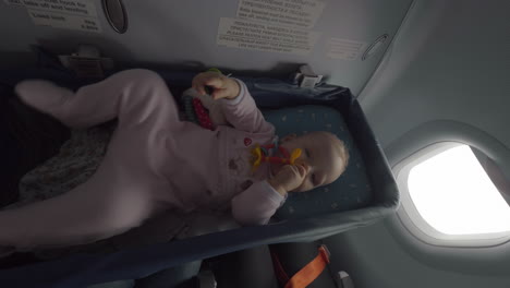 baby girl in airplane bassinet