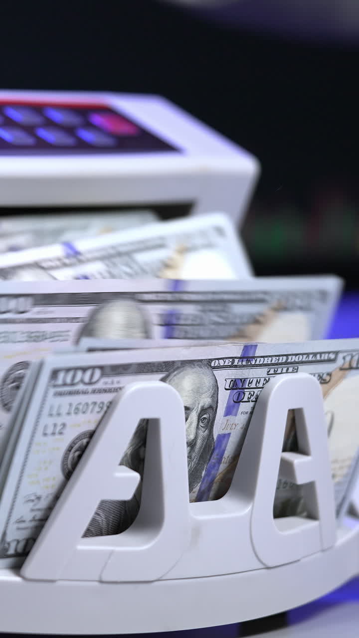 Counting operation on electronic cash machine. Counting money on bank automatic equipment. Paper banknotes in modern money counting machine. Investment capital operations. Vertical video