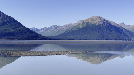 panorama of mountains and reflection along turnagain arm in alaska