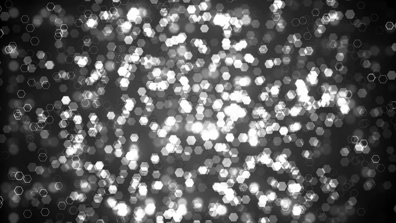 Black glitter hexagon sparkles on dark background. Abstract animation.