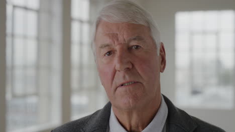 portrait of elderly caucasian man looking serious at camera in apartment background calm pensive senior male