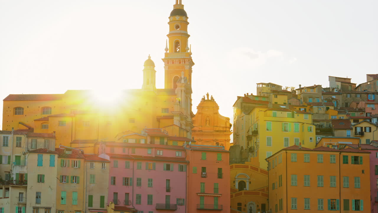 Cartello blu Mentone sulla strada con gli edifici colorati della città sullo sfondo, Mentone, Francia