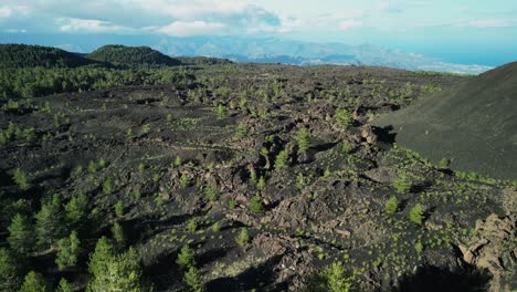 Ascending-on-lunar-landscape-with-forest-ecosystem,-near-volcano