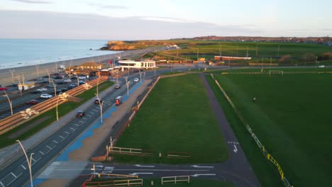 A-panning-shot-from-a-drone-of-the-coast-at-South-Shields,-South-Tyneside,-UK,-ending-at-the-Amphitheatre