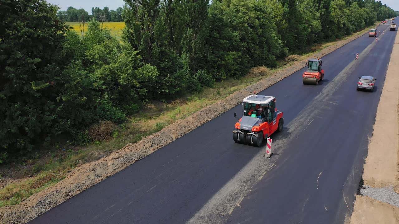 Aerial view of asphalt rollers. Road construction works with roller compactor machine