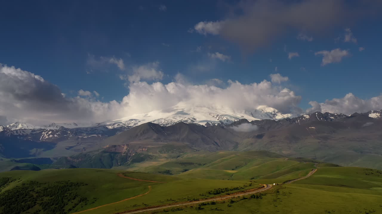 Elbrus Region. Flying over a highland plateau. Beautiful landscape of nature. Mount Elbrus is visible in the background.
