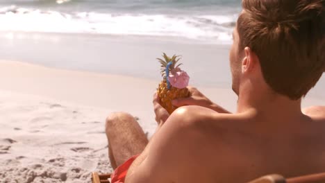 Man-drinking-in-a-pineapple