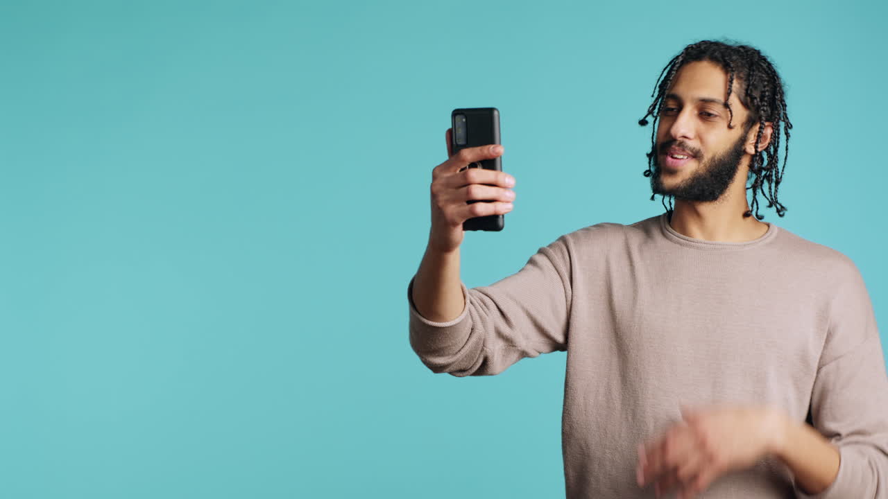 Excited person bonding with mate using mobile phone video call