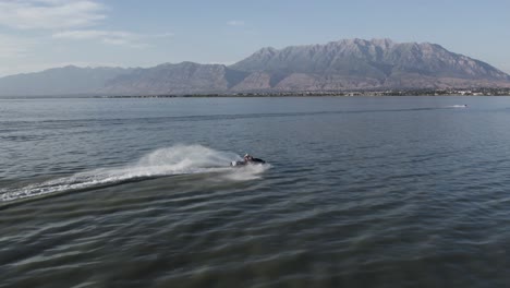 waverunner rider on utah lake with timpanogos mountain backdrop, aerial