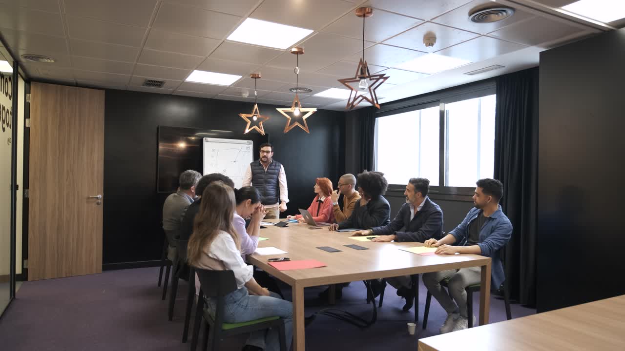 Aggressive businessman scolding diverse team during presentation