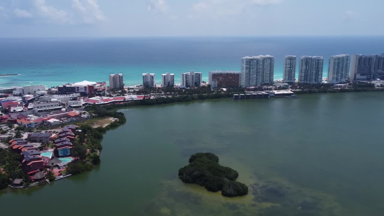 Aerial tour of Cancun hotel zone with blue Caribbean sea and Nichupte Lagoon, Mexico