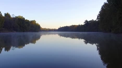 Drone-flies-over-foggy-creek-on-a-clear-day