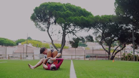 Couple playing rugby on a sports field