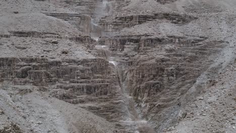 aerial fly forward multiple muddy waterfalls in israel judean desert, drone shot