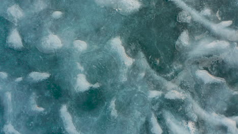 aerial shot of icy blue lake