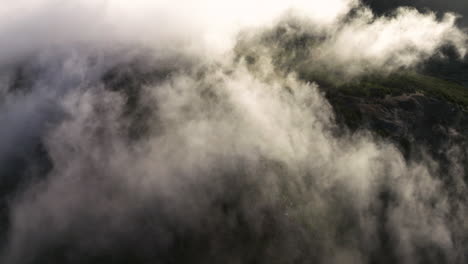 rolling misty clouds over mountain peaks of pico do arieiro in madeira island, portugal