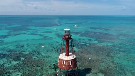 an 4k drone shot of an abandoned lighthouse, in a remote area of the caribbean sea, near bimini, bahamas