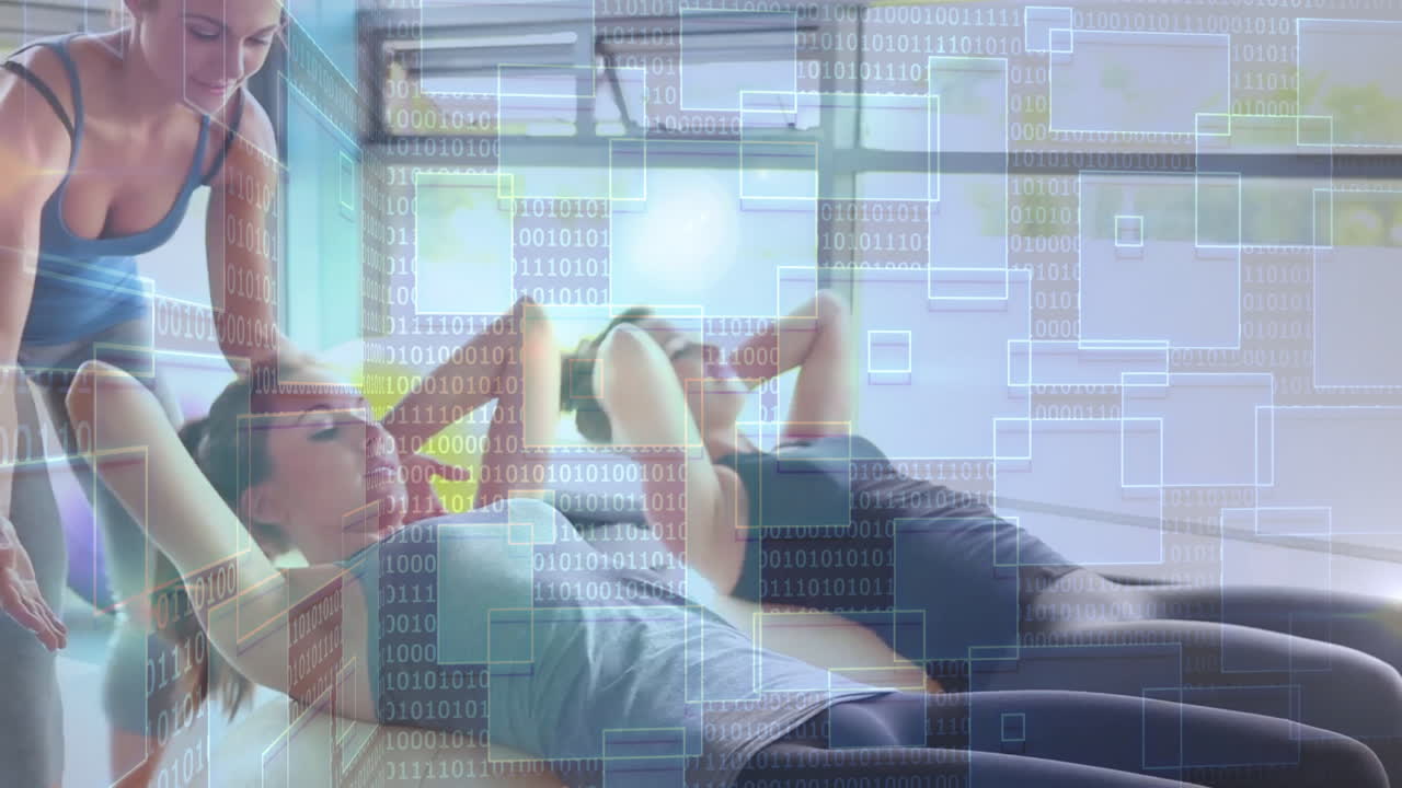 Fitness trainer guiding client performing crunches on mat in studio, showing binary code rectangles