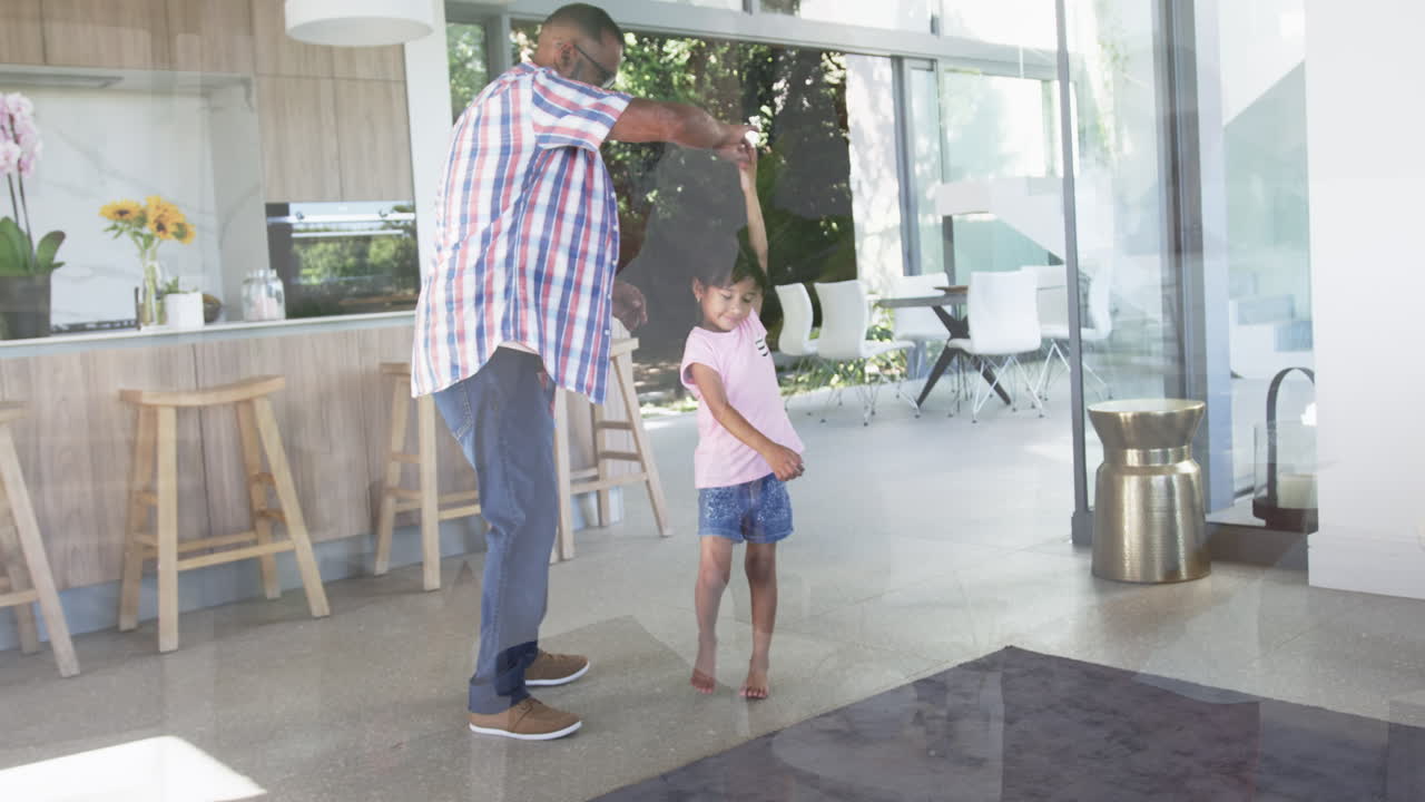 Biracial girl bakes with her grandparents, sifting flour; kitchen setting