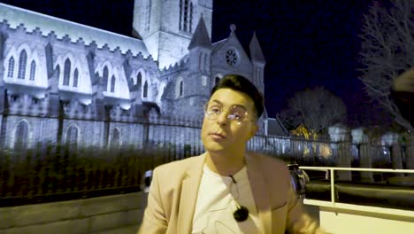 Irish-Television-star-Comedian-Alan-McGarry-extoling-the-virtues-of-Dublin-city-on-a-horse-drawn-carriage-tour-with-the-ancient-flood-lit-Christchurch-Cathedral-in-the-background