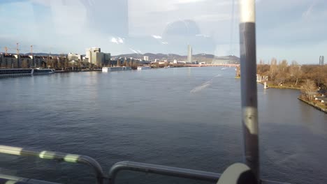 view from a car while driving over the danube river in vienna, austria