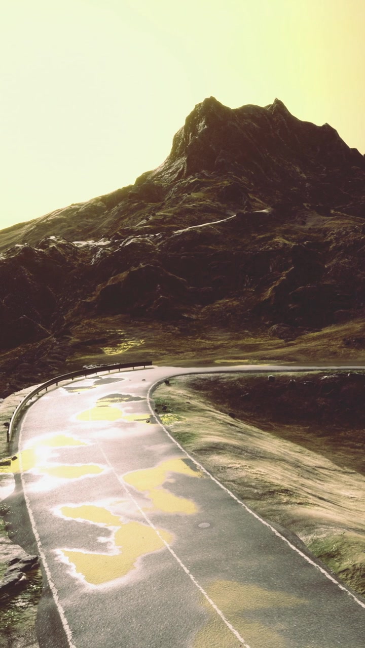Road curves along mountain landscape under golden light in evening time