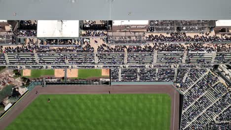 drone above, crowd in stands of multi-tiered seating area of baseball stadium