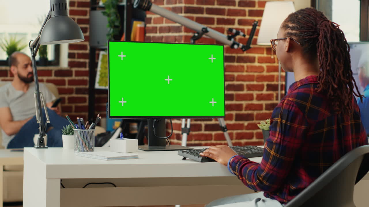 African american freelancer watching computer with greenscreen