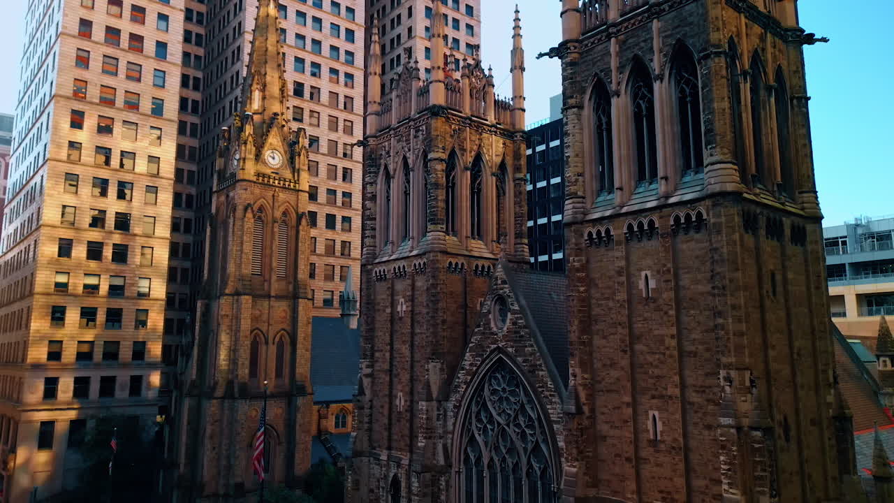 Striking architecture of the Trinity Cathedral in the downtown of Pittsburg, Pennsylvania, USA. Drone footage along stunning façade of the Episcopal church descending over the street