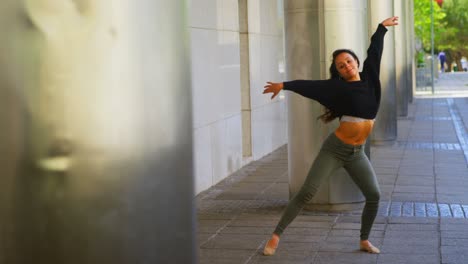 Young-female-dancer-performing-dance-on-the-sidewalk-in-the-city-4k