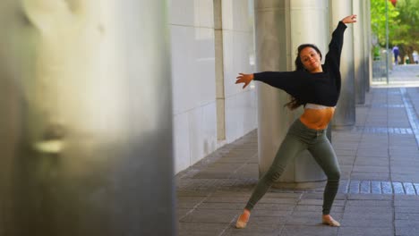 young female dancer performing dance on the sidewalk in the city 4k