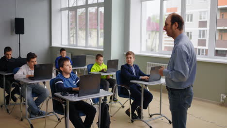 students in a classroom using laptops