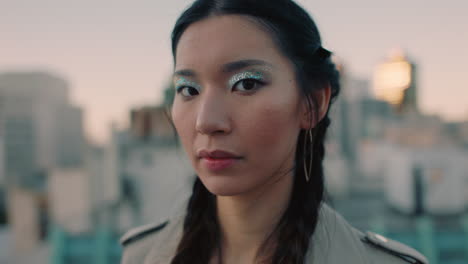 portrait beautiful young asian woman on rooftop at sunset wearing colorful makeup looking confident in urban city