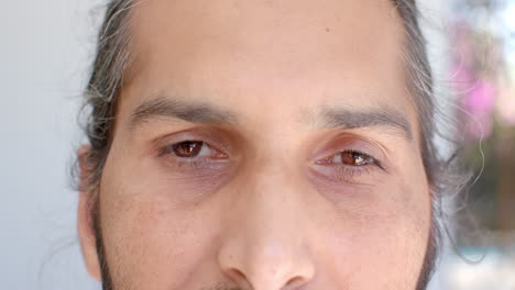 close-up of man with closed eyes, relaxing and meditating at home