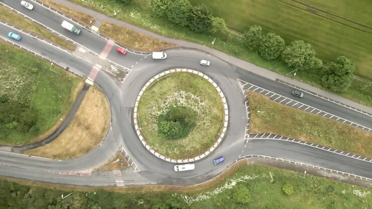4K aerial static footage of a junction on the A64 near Scarborough with cars and trucks and green countryside