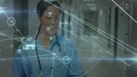 analyzing data with digital network overlay, healthcare professional in hospital
