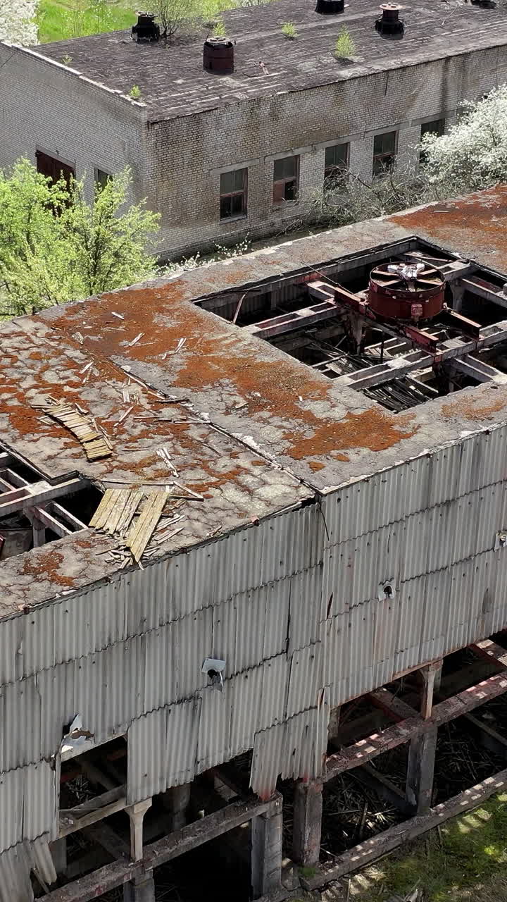 Aerial shot of abandoned old city. Empty damaged buildings exterior. Vertical video