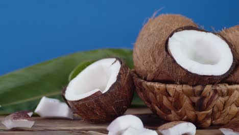 pieces of coconut fall on the wooden table.