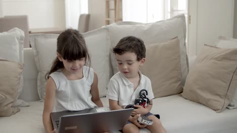 Cheerful-young-girl-using-laptop-by-herself