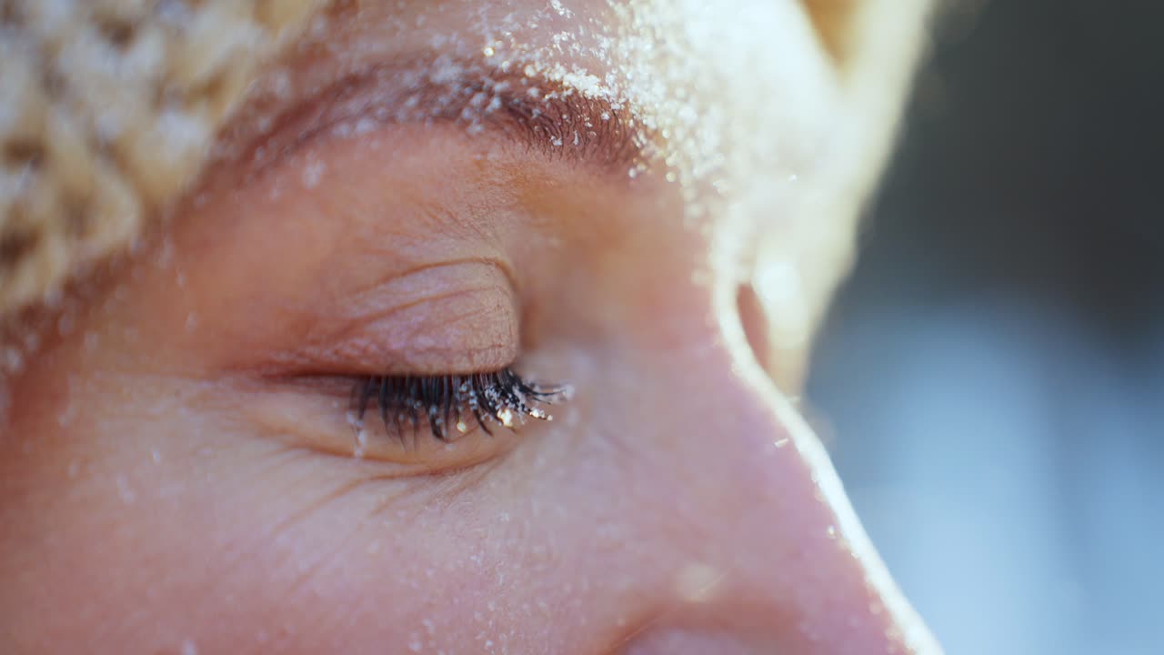 Woman's face covered in snow