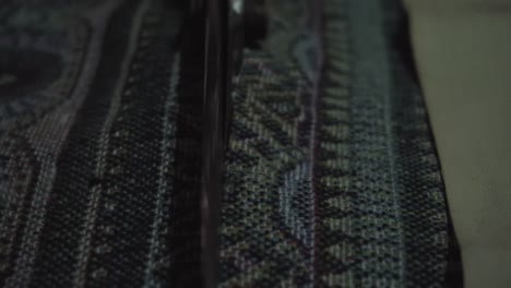 close up look, old lady tailor use scissors to cut traditional thai fabric