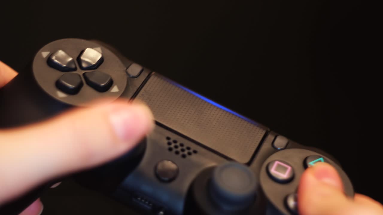 Person playing a video game using a controller