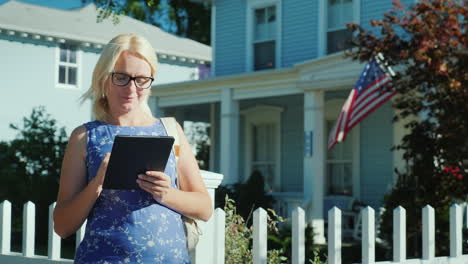 Woman-With-Tablet-by-American-House