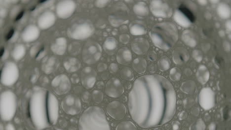 Macro-shot-of-soap-cells-over-screen-showing-a-animation