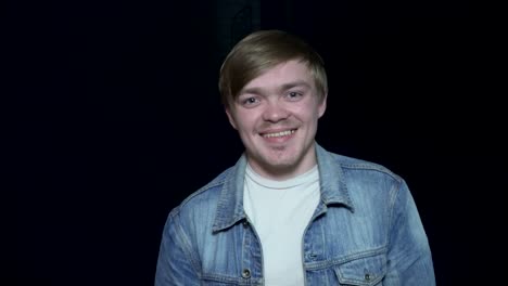 smiling young man in denim jacket