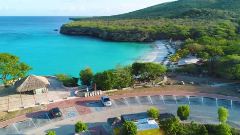 drone rises on parking lot of grote knip to reveal empty serene beach before hot day