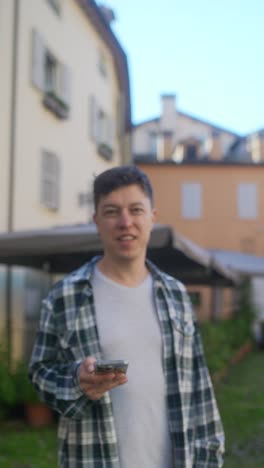 man holding a phone in a european city