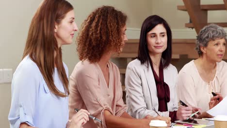 concentrated women taking notes and discussing