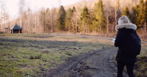 tourist reading map on trail in mountains 3